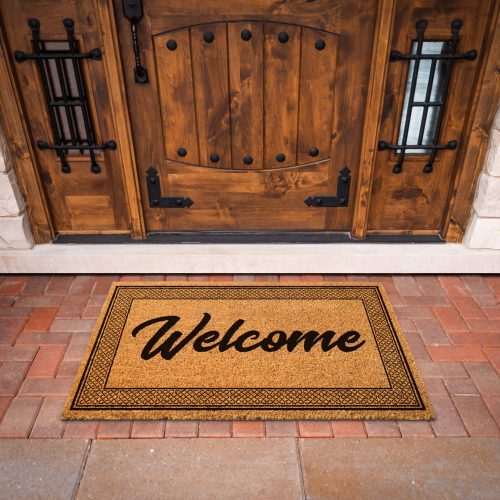 Welcome Mat At Custom Front Door Of House.